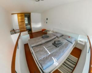 a large bed on a boat in a room at Hedona vineyard apartment in Sarajevo