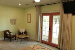 a living room with a sliding glass door and a table at Relax and Enjoy Bayou Grande in Pensacola