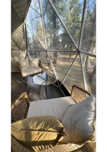 a room with a bed and pillows in a tent at Deer Glamping in Ciudad Lujan de Cuyo