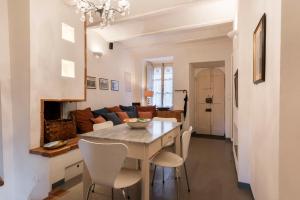 cocina y sala de estar con mesa y sillas en Medieval Cottage, en Monte San Savino