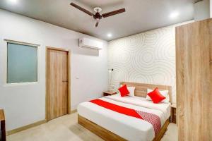 a bedroom with a bed with red pillows on it at JPS DELIGHT HOTEL in New Delhi