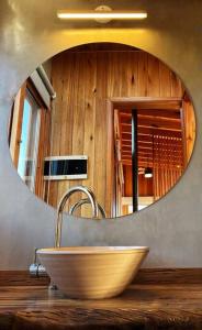 a bathroom with a bowl sink and a mirror at El Pedregal - Casa Sur Solo Adultos in La Población