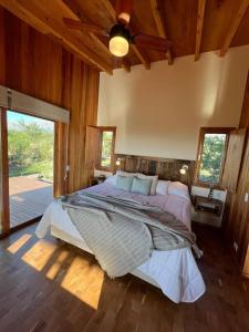 a bedroom with a large bed in a room with wooden walls at El Pedregal - Casa Sur Solo Adultos in La Población