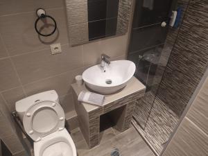 a bathroom with a sink and a toilet at Villa Anastasia in Limenas +39 photos
