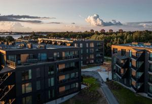 an aerial view of a building with a city in the background at New Nordic 2BR: Beach & Forest, Family-Friendly in Tallinn