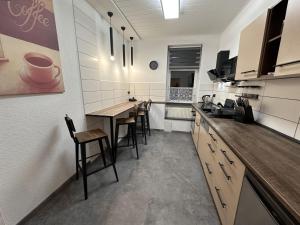 a kitchen with a table and some chairs in it at FeWo BiBo in Freiberg +18 photos