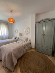 ein Schlafzimmer mit 2 Betten und einem großen Schrank in der Unterkunft El Mirador de Velez Blanco in Vélez-Blanco