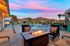 a patio with a fire pit and a pool at Joshua Tree Pool/Spa Villa in Joshua Tree