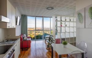 a kitchen with a table and a large window at Lo Spettacolo in Macerata