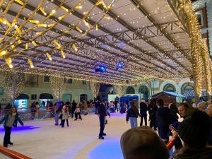 people skating on an ice rink in a building with christmas lights at Bilocale degli Innamorati in Terni