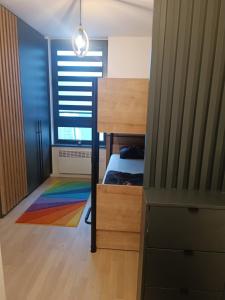 a bedroom with a bunk bed and a colorful rug at Studio apartman Bjelašnica SAMBA in Bjelašnica