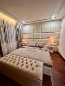 a bedroom with a large bed with a large headboard at Shine HolliDay Villa HaNoi in Hanoi