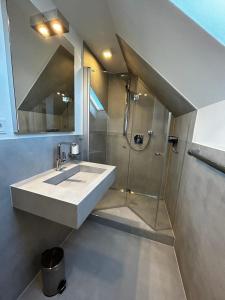 a bathroom with a sink and a shower at Altstadt Maisonette Wohnung in Brilon