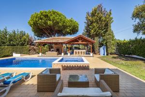 een zwembad met een prieel naast een zwembad bij Villa Cambria by OCvillas in Albufeira