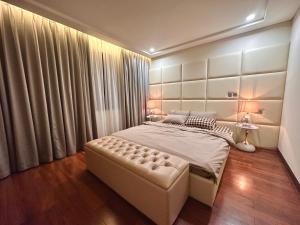 a bedroom with a bed and a large window at Shine HolliDay Villa HaNoi in Hanoi