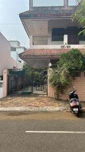 a motorcycle parked in front of a house at Chandrajyoti Villa 2 Garden Facing. in Nagpur