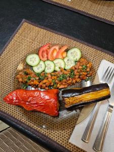 a plate of food with sushi and vegetables on a table at Guesthouse different in Tbilisi City