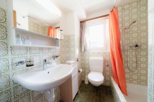 a bathroom with a sink and a toilet at Hotel Old JNN in Klosters Serneus