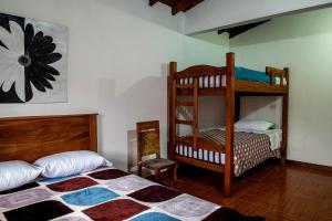 a bedroom with two bunk beds and a chair at Hostal Café Racer in Jardin