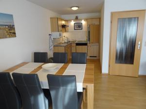 a kitchen and dining room with a table and chairs at Clemens 1 in Wangerooge