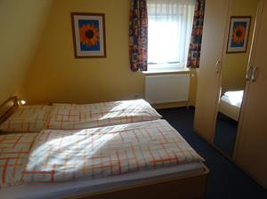 a small bedroom with a bed and a window at Clemens 1 in Wangerooge