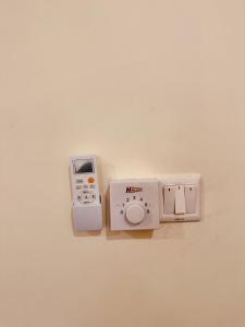 a wall with an electronic device on a wall at Oceans-Opulence/3BR-5 BEDS in Dar es Salaam