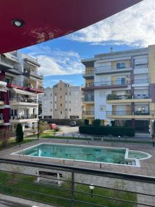 a swimming pool in front of some apartment buildings at Parma’s Pool apartment in Perea