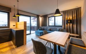a living room with a table and a couch at Malojerhof in Lana