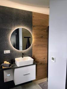 a bathroom with a sink and a mirror at Przystanek Przylasek in Grywałd