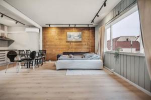 a bedroom with a bed and a dining room at Dinbnb Apartments I Romantic Surrourings in Bergen