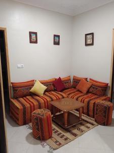 a living room with a couch and a table at Maison d'hôte Najah in Khenifra