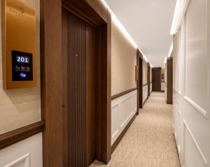 a corridor of a hospital with a clock on the wall at Dream Inn Karaköy Bosphorus in Istanbul