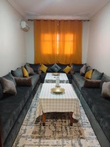 a living room with a couch and a table at Maison d'hôte Najah in Khenifra