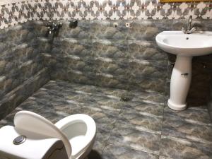 a bathroom with a toilet and a sink at Hotel Five Season Lahore in Lahore +19 photos