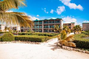 a resort with palm trees in front of a building at Suite A203 @ Mara Laguna in San Pedro