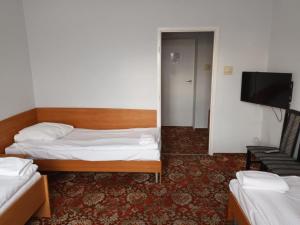 a bedroom with a bed and a flat screen tv at AGRO obiekt hotelowy in Wrocław