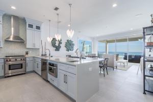 a kitchen with stainless steel appliances and a dining room at Wait'n on Sundown in Destin