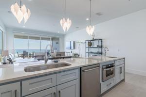 a kitchen with a sink and a view of the ocean at Wait'n on Sundown in Destin
