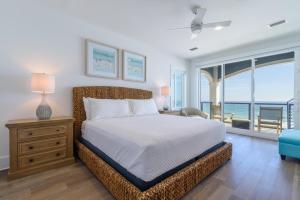 a bedroom with a bed and a view of the ocean at Wait'n on Sundown in Destin +26 photos