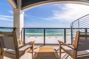 two chairs on a balcony with a view of the beach at Wait'n on Sundown in Destin