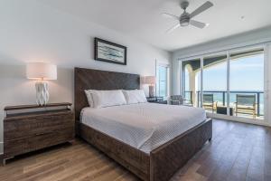 a bedroom with a bed with a view of the ocean at Wait'n on Sundown in Destin