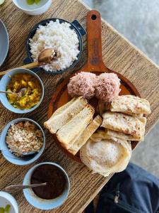 a plate of bread and rice on a table at Sea View Clay House in Hiriketiya