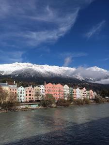 a city with buildings and snow covered mountains in the background at Apartment Enarina in Telfs in Telfs