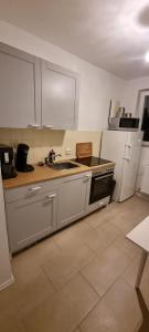 a kitchen with a stove and a refrigerator at Ferien- & Monteurs Wohnung in Munster im Heidekreis