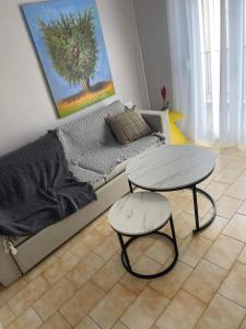 a living room with a couch and a table at Minimal House in Paralia Katerinis +1 photo