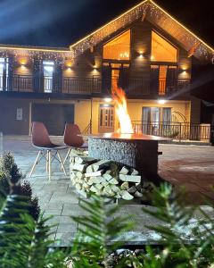 a fire pit in front of a house at night at Чорногора in Vorokhta