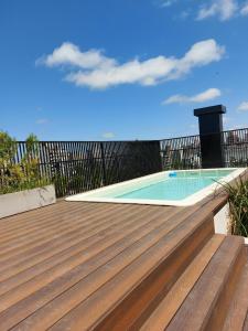 a wooden deck with a swimming pool on top of it at GRATA NERA in Rosario