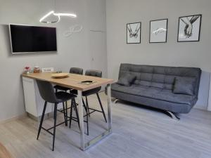 a living room with a table and a couch at Cà Fiamma in Casale Monferrato