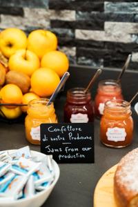 a table with jars of jam and a plate of food at Agriturismo Val Castel in Sporminore