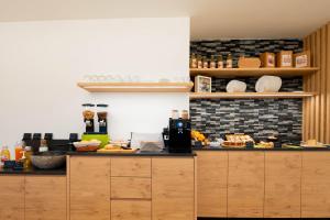 a kitchen with a counter with food on it at Agriturismo Val Castel in Sporminore